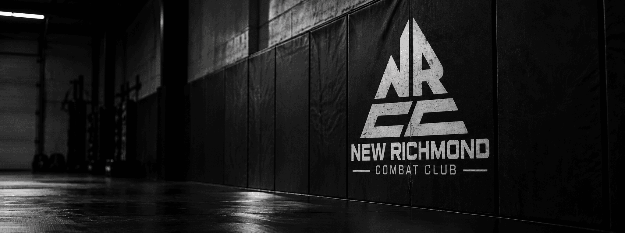 New Richmond Combat Club triangular mark on the academy wall pads